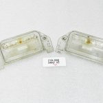 Oriģinālais Lancia Thema II 300C numura zīmes apgaismojuma korpuss, pāris 04805846AA