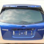 Mazda CX7 I MK1 aizmugurējā durvju apakšējā bagāžnieka vāka krāsa 34J Aurora Blue Mica