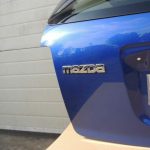 Mazda CX7 I MK1 aizmugurējā durvju apakšējā bagāžnieka vāka krāsa 34J Aurora Blue Mica