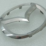 Oriģinālā Mazda 6 GJ priekšējā radiatora režģa emblēma Mascot GHP951731, GHP9-51-731